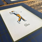 Close-up of vintage-style golfer illustration print with traditional tartan plaid border from the 3-piece golf wall art set. High-quality clubhouse wall decor and thoughtful Father&