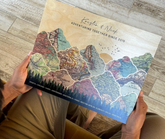 A person holding a personalized map of vintage map with travel destinations.