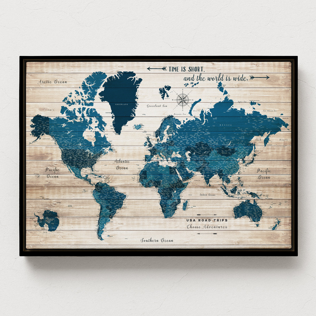 World map poster with wooden texture and blue oceans on a white wall. Roadtrips of USA